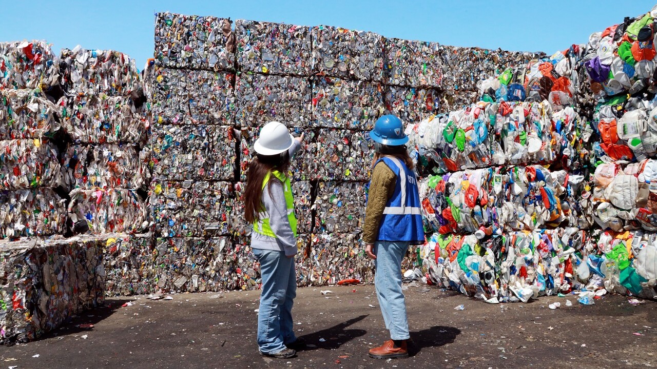 People in front of recyclables
