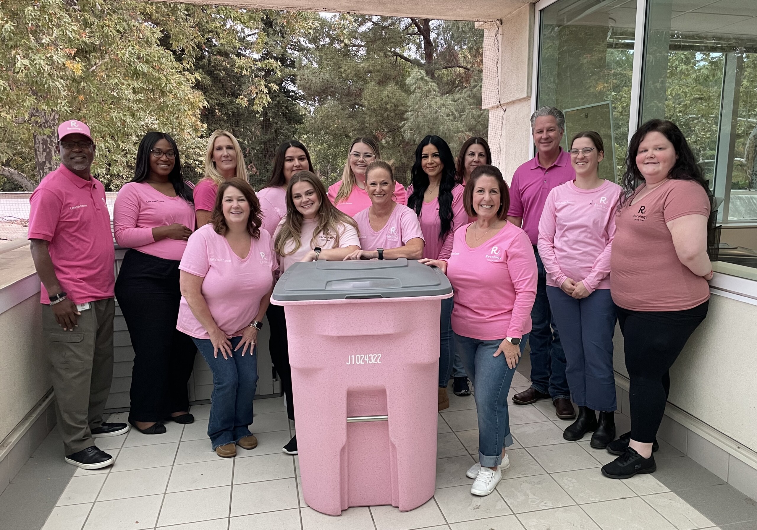 Recology employee-owners with a pink toter